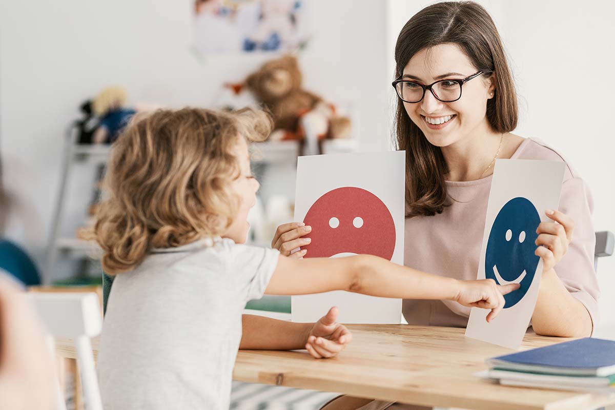 a woman works on a child's autism communication