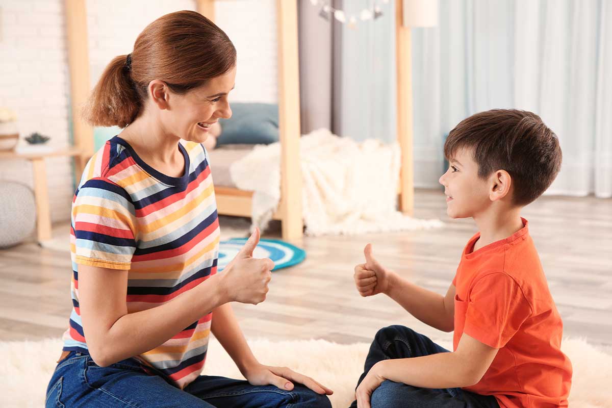 a woman works on skills for a speech delay in a child